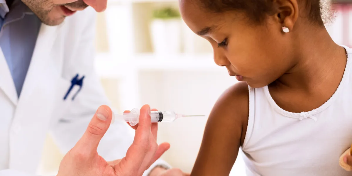 médecin pédiatre injection de vaccin à la jolie fille africaine