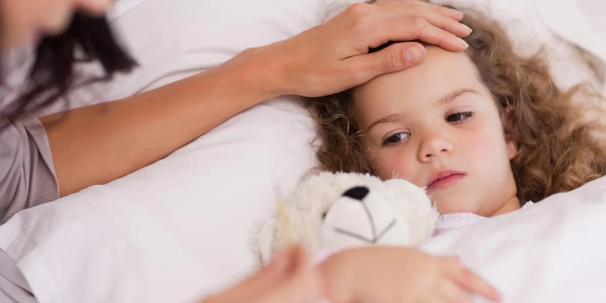 young mother taking care of her ill daughter