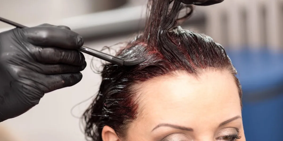 hairdresser coloring client hair