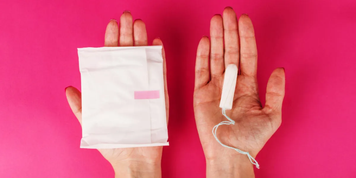 woman holding menstrual tampon and pad on a pink background menstruation time hygiene and protection