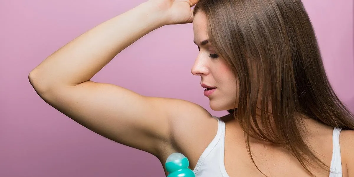 woman holding a deodorant antiperspirant bottle woman holding a deodorant antiperspirant bottle