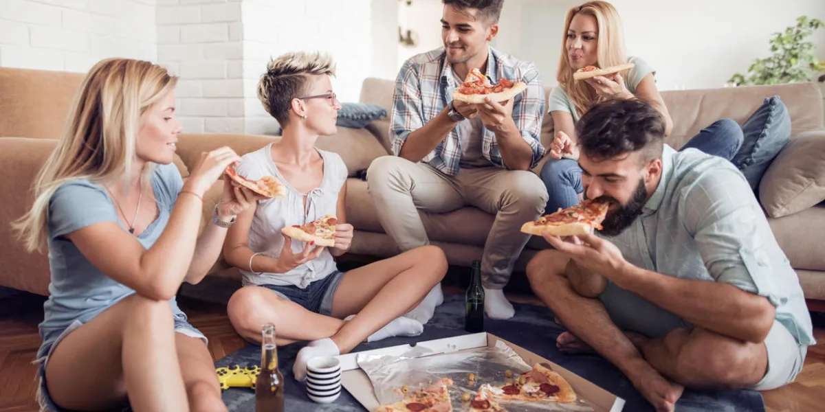 pizza loversgroup of playful young people eating pizza while having fun together pizza loversgroup of playful young people eating pizza while having fun together