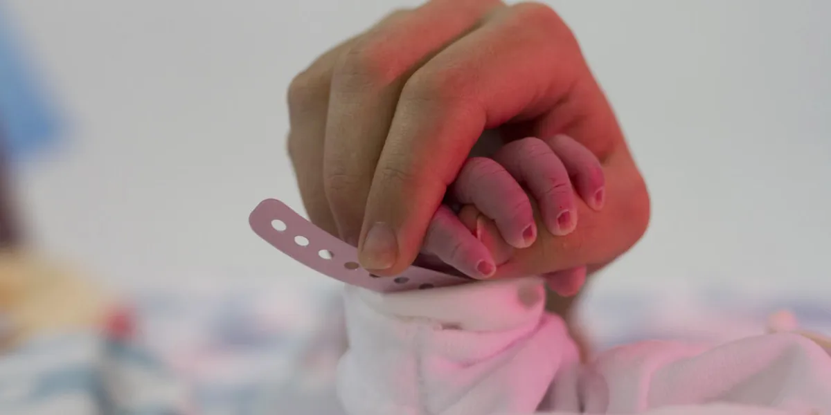 newborn grabs finger of mother newborn grabs finger of mother