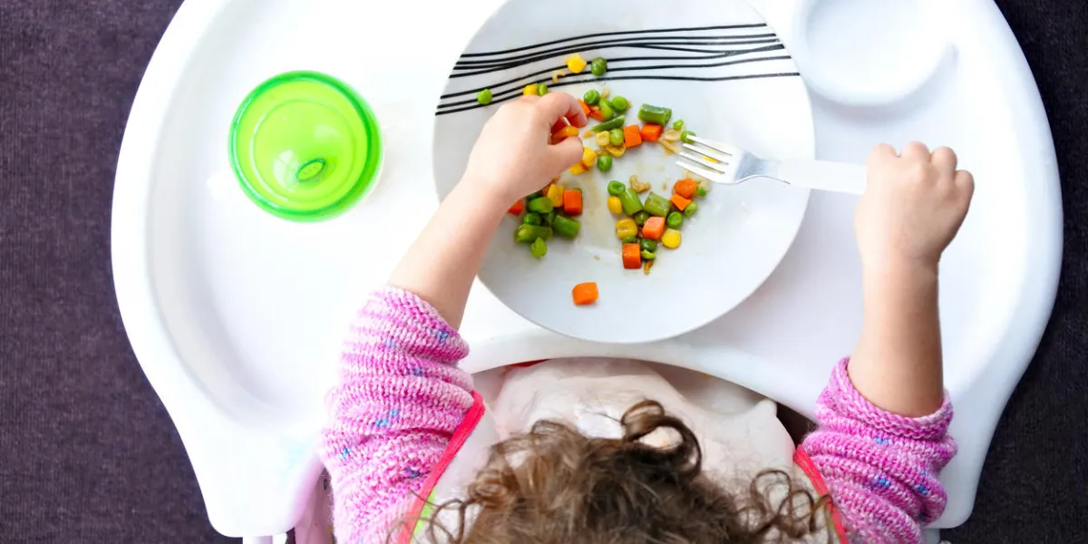 above view of a little toddler child eats vegetables childhood and children health care concept real people copy space above view of a little toddler child eats vegetables childhood and children health care concept real people copy space