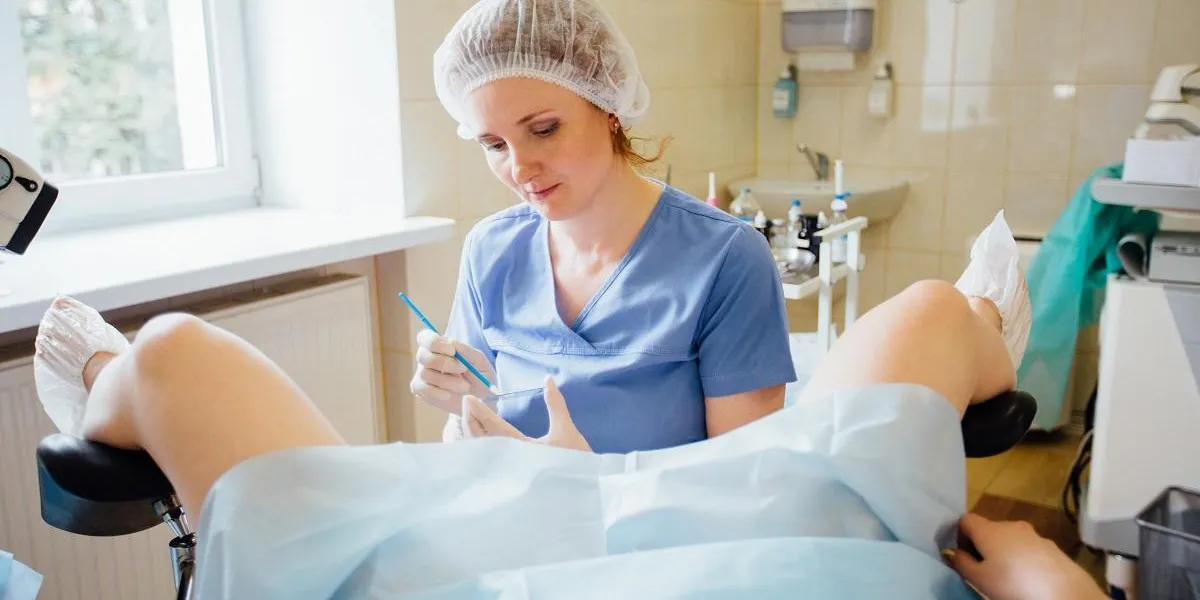 cheerful female red hair practitioner is working with patient vaginal smear cheerful female red hair practitioner is working with patient vaginal smear