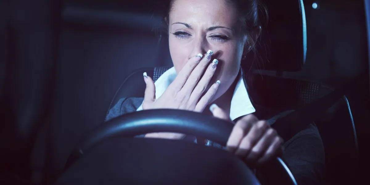 distracted exhausted tired woman driving a car late at night
