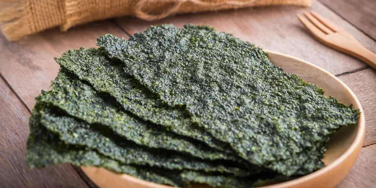 crispy dried seaweed on wooden plate crispy dried seaweed on wooden plate