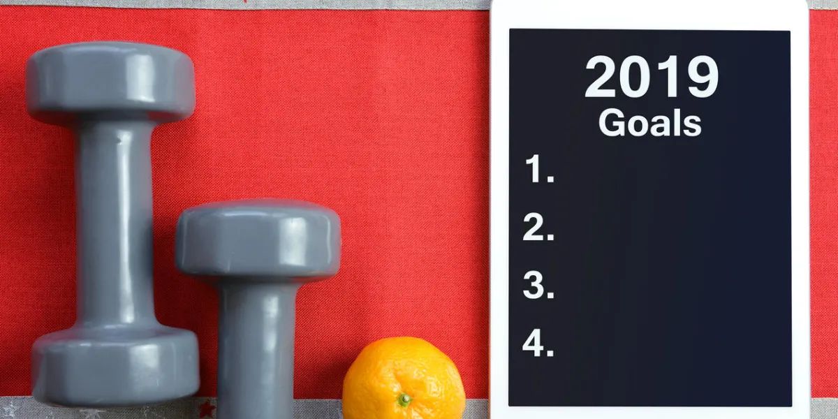 dumbbells with mandarin and tablet computer healthy resolutions for the new year dumbbells with mandarin and tablet computer healthy resolutions for the new year