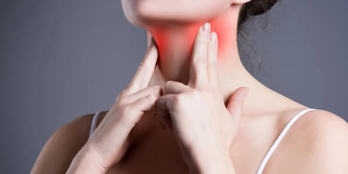 sore throat, woman with pain in neck, gray background, studio shot sore throat, woman with pain in neck, gray background, studio shot