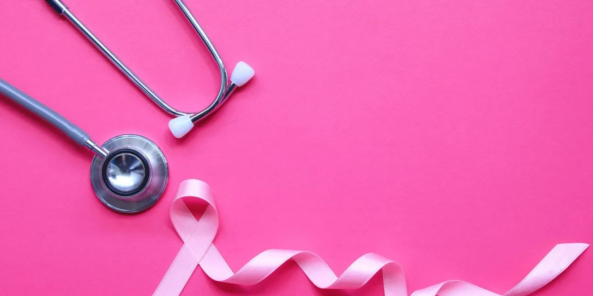 pink ribbon and stethoscope on pink background, symbol of breast cancer in women, health care concept