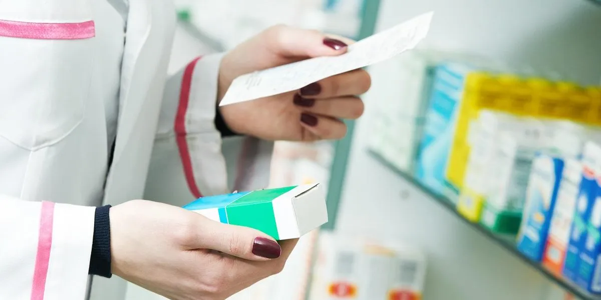 closeup hand of woman pharmacist with prescription and medicine at drugstore closeup hand of woman pharmacist with prescription and medicine at drugstore