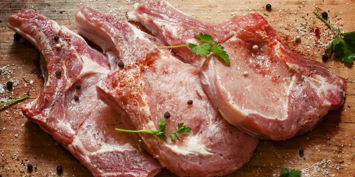 raw meat steak with spices on a wooden board, selective focus
