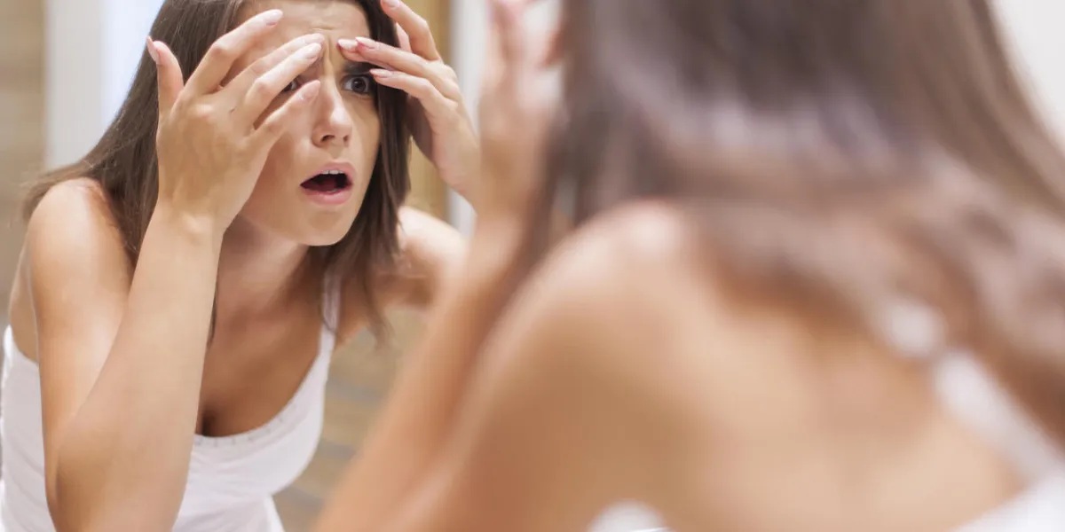 shocked woman squeezing pimple in bathroom shocked woman squeezing pimple in bathroom