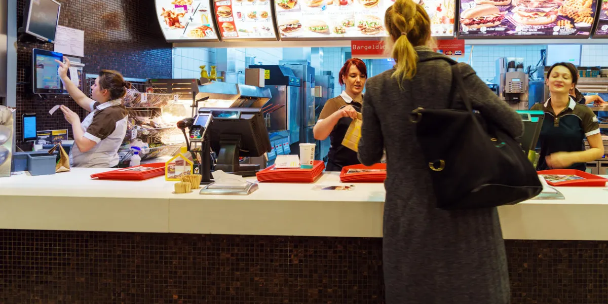 munich, germany - october 24, 2017 the girl receives an order in the interior of the mcdonald's fast-food restaurant munich, germany - october 24, 2017 the girl receives an order in the interior of the mcdonald's fast-food restaurant