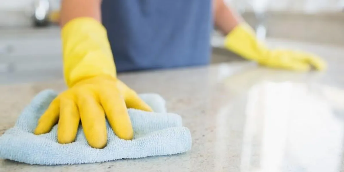 woman cleaning the counter in the kitchen woman cleaning the counter in the kitchen