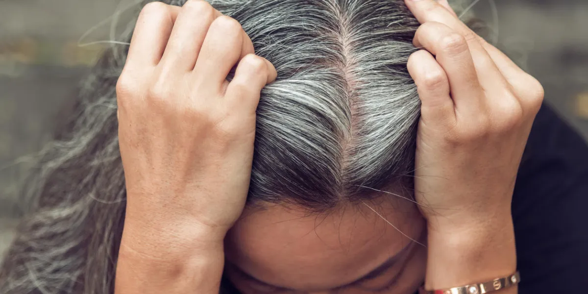 closeup sad asian young beautiful woman and gray hair with worried stressed face expression looking down closeup sad asian young beautiful woman and gray hair with worried stressed face expression looking down
