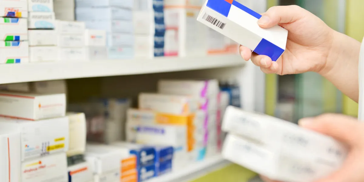 pharmacist holding medicine box and capsule pack in pharmacy drugstore pharmacist holding medicine box and capsule pack in pharmacy drugstore