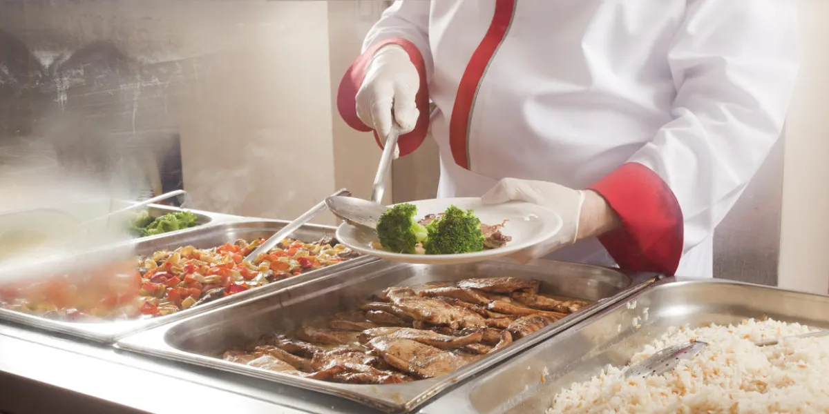 chef standing behind full lunch service station
