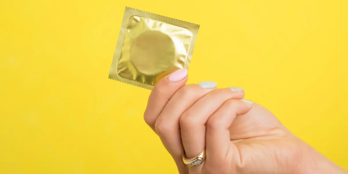 woman holding a condom woman holding a condom