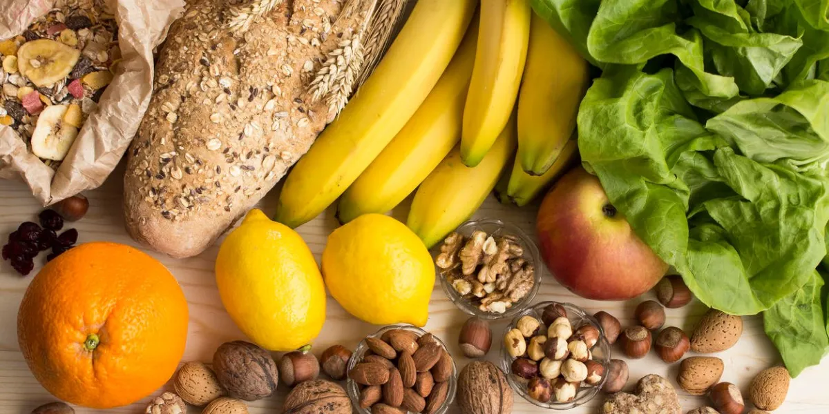 various healthy food, tropical fruits, nuts, muesli, whole wheat bread and biscuits, lettuce, apple