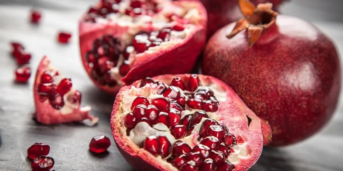 red juice pomegranate on dark background red juice pomegranate on dark background