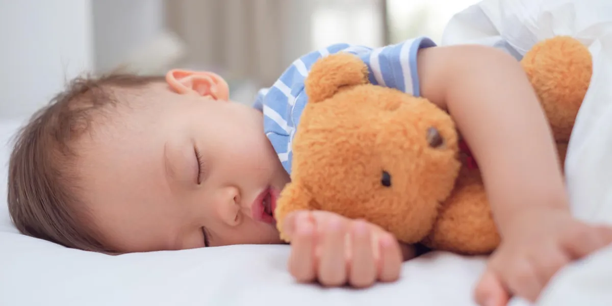 cute healthy little asian 18 months   1 year old toddler baby boy child sleeping   taking a nap under blanket in bed while hugging teddy bear, daytime sleep, kid deep sleeping, sweet dream concept