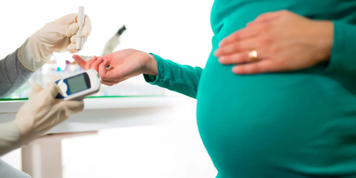 a close-up of a pregnant woman having her blood sugar  glucose checked
