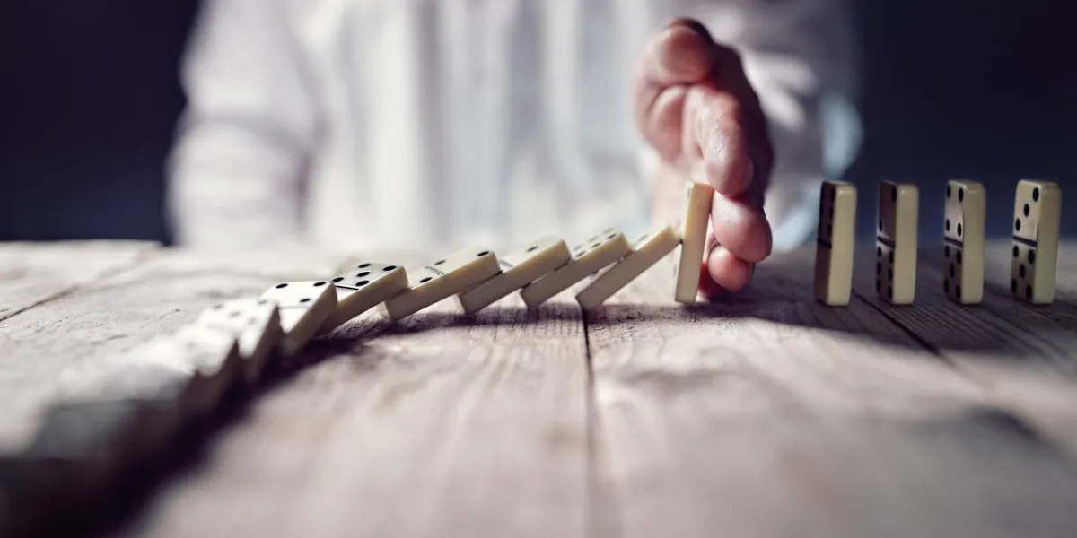 stopping the domino effect concept for business solution, strategy and successful intervention stopping the domino effect concept for business solution, strategy and successful intervention