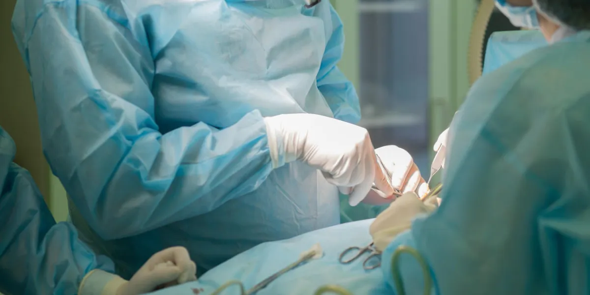 surgical team performing cosmetic surgery in hospital operating room breast augmentation at medical clinic breast enlargement, enhancement mammaplasy surgical team performing cosmetic surgery in hospital operating room breast augmentation at medical clinic breast enlargement, enhancement mammaplasy