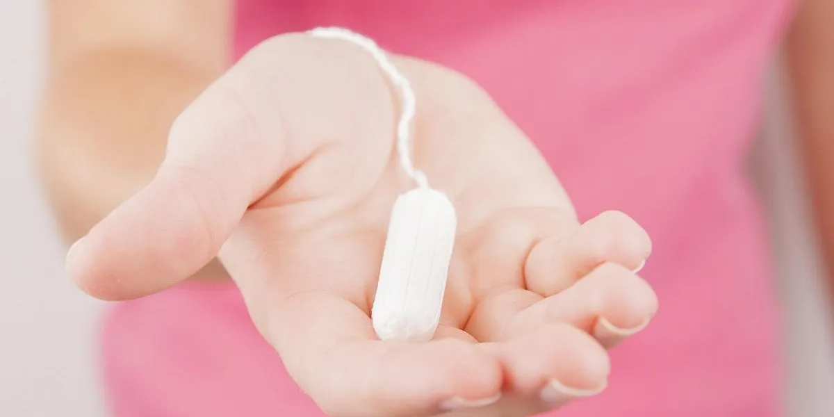 young woman holding tampon preparing for menstruation