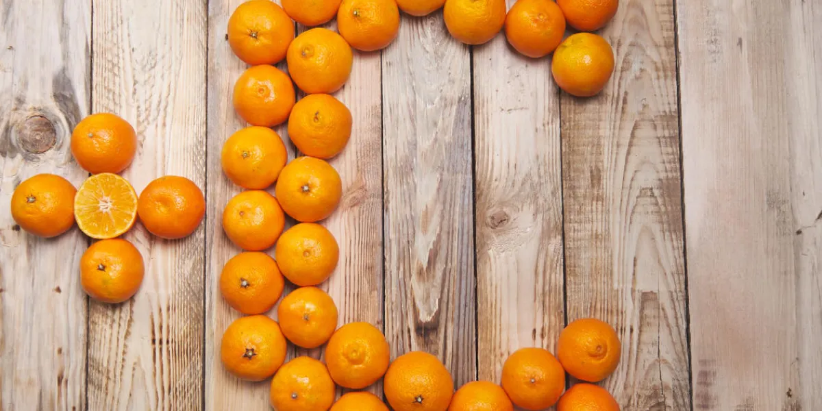 vitamin c is laid out tangerines on a wooden background