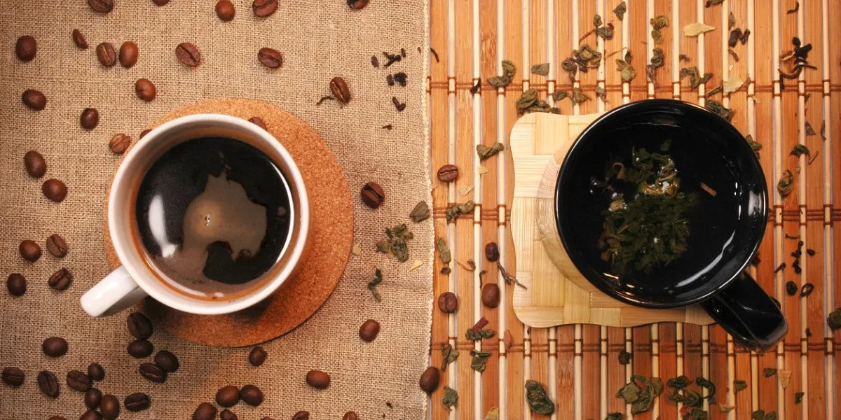 two cups, one with tea and the other with coffee