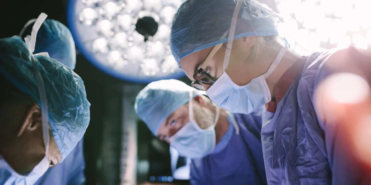 concentrated female surgeon performing surgery with her team in hospital operating room medics during surgery in operation theater concentrated female surgeon performing surgery with her team in hospital operating room medics during surgery in operation theater