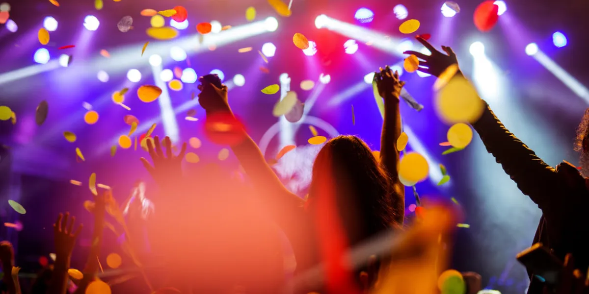 confetti falling over the crowd on a music festival