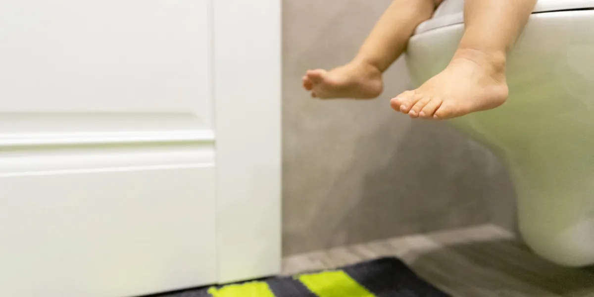 baby feet on the toilet children's concept restroom