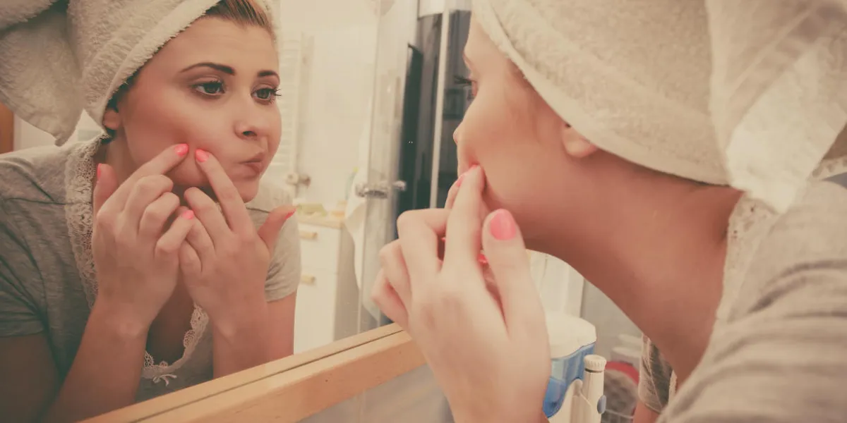 woman looking at her reflection in mirror thinking about her complexes having serious face expression, analyzing face skin complexion squeezing pimples woman looking at her reflection in mirror thinking about her complexes having serious face expression, analyzing face skin complexion squeezing pimples