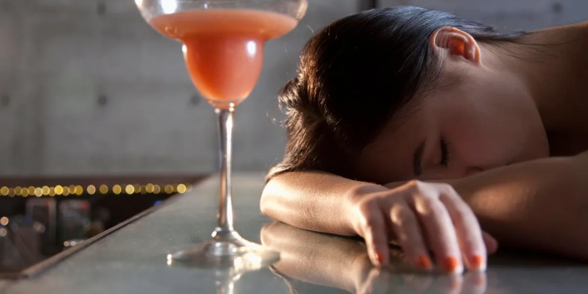 young woman passed out on bar counter