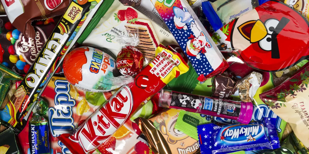 moscow, russia - january 02, 2016  kinder surprise, angry birds, lindor, kit kat, milky way, tempo, mambo, brasilica, pancake, michaszki and many other candies, chocolates and sweets for kids manufactured by different companies studio shot