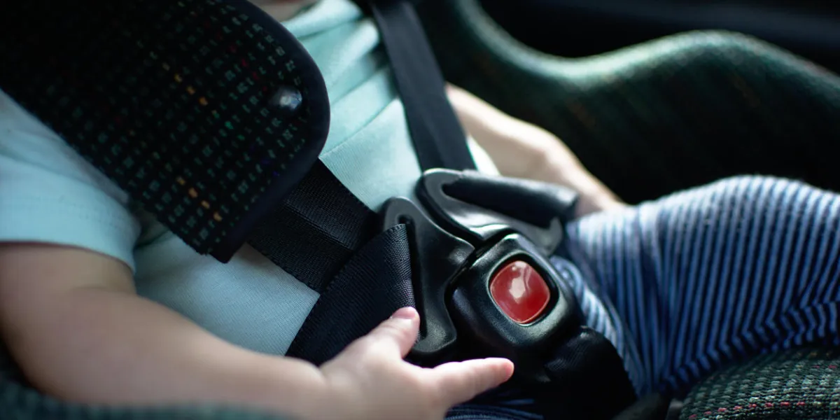 baby in rear facing car seat has the safety belt on