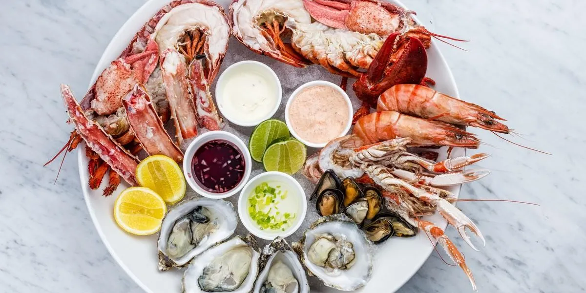 fresh seafood platter with lobster, mussels and oysters on marble desk fresh seafood platter with lobster, mussels and oysters on marble desk
