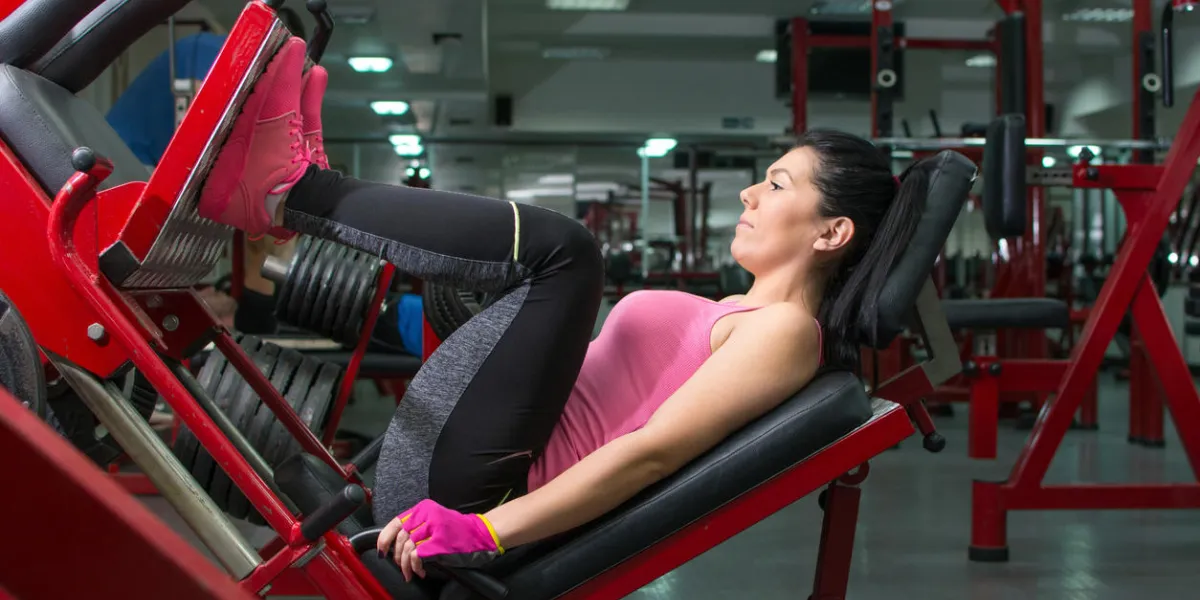 girl doing the leg press at the gym girl doing the leg press at the gym