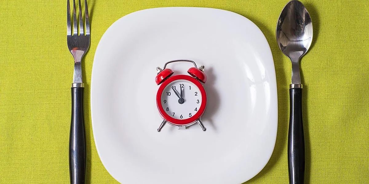 time to eat concept, clock on plate