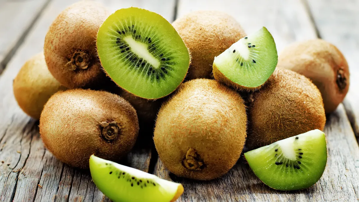 kiwi on white wood background tinting selective focus
