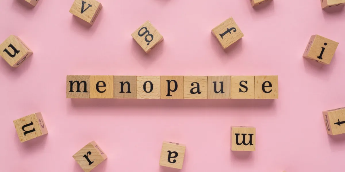 menopause word on wooden block flat lay view on light pink background menopause word on wooden block flat lay view on light pink background