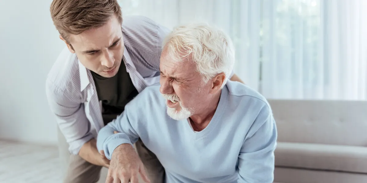 sudden dizziness kind man helping senior man who groaning