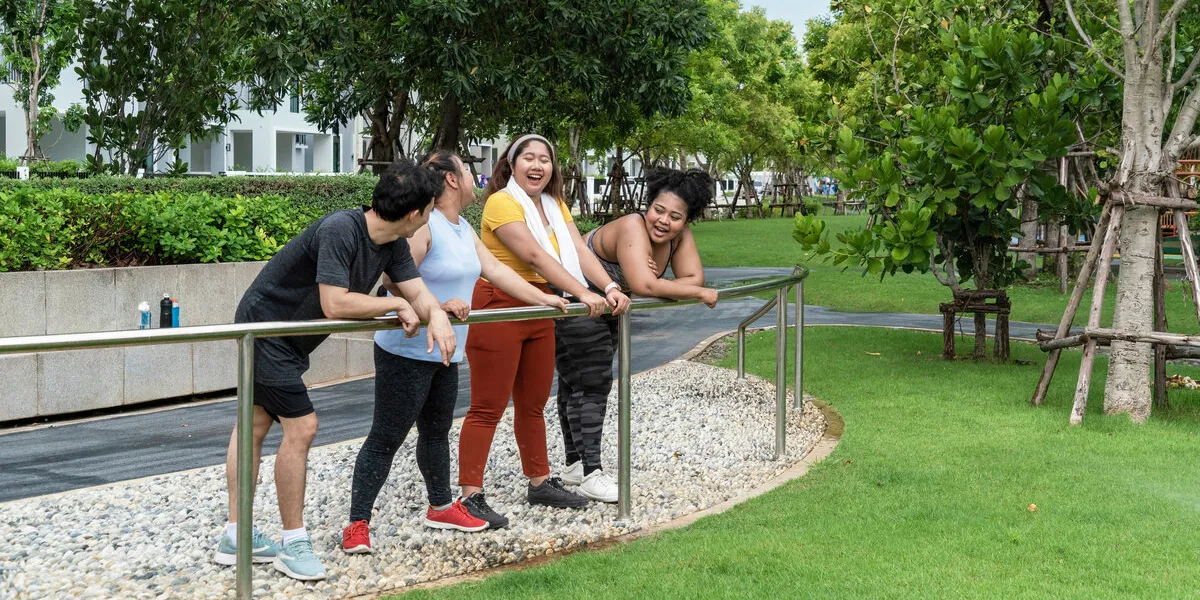 group of overweight girls in sportswear stand talking in the gar