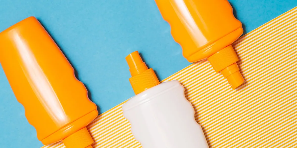 bottles of sunscreen cream or lotion flat lay on the blue and yellow background with copy space spf summer skin protect, holiday, sunburn concept bottles of sunscreen cream or lotion flat lay on the blue and yellow background with copy space spf summer skin protect, holiday, sunburn concept