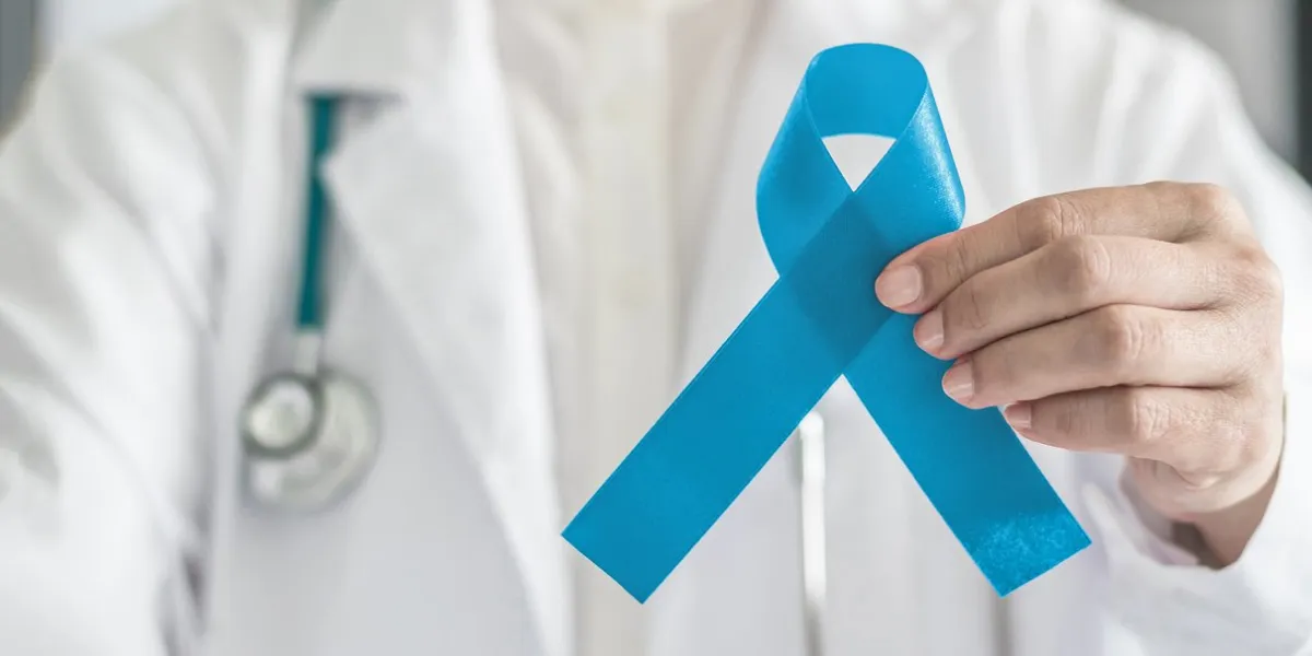 blue ribbon symbolic for prostate cancer awareness campaign and men's health in doctor's hand blue ribbon symbolic for prostate cancer awareness campaign and men's health in doctor's hand