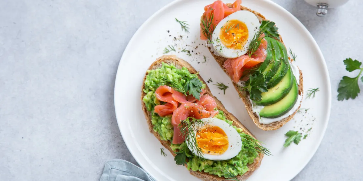 toasts with avocado, smoked salmon and egg , top view