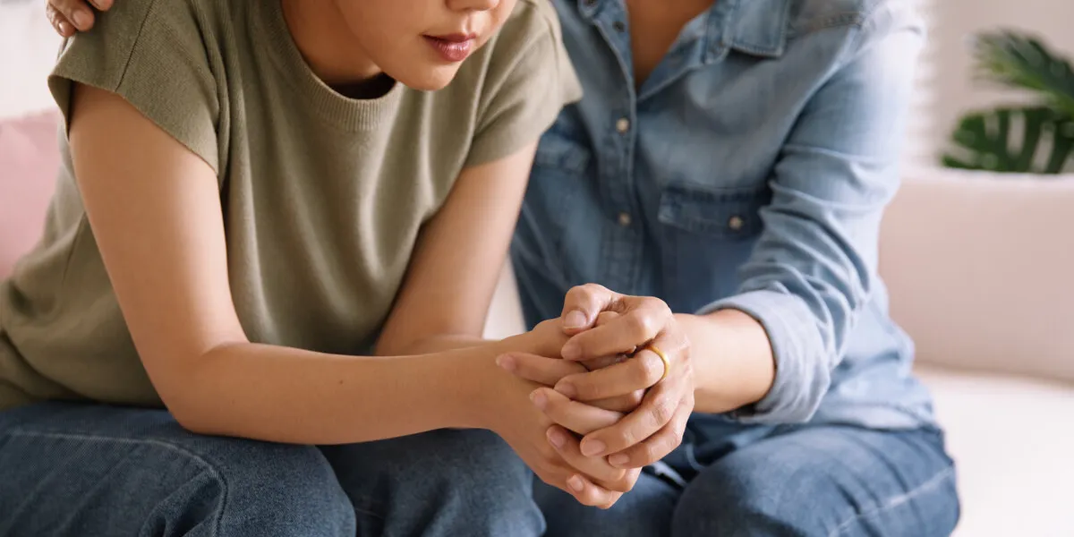middle aged asia people old mom holding hands trust comfort help young woman talk crying stress relief at home mum as friend love care hold hand adult child feel pain sad worry of life crisis issues